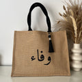 Sac en Toile de Jute avec Pompon Noir et Personnalisé avec Prénom en Calligraphie Arabe centré